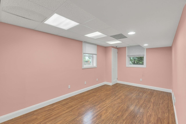 5 E Walnut St, Long Beach, NY 11561 - empty room featuring wood finished floors, plenty of natural light, baseboards, and a paneled ceiling