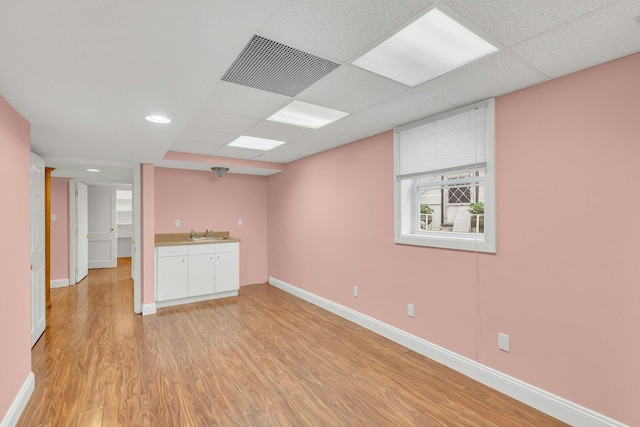 5 E Walnut St, Long Beach, NY 11561 - spare room with a sink, light wood-type flooring, a paneled ceiling, baseboards, and recessed lighting