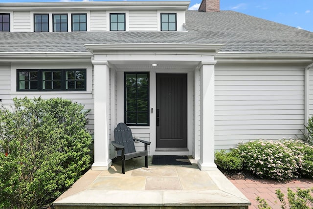 27 Lavender Ln, Rye Brook, NY 10573 - doorway to property featuring roof with shingles and a chimney