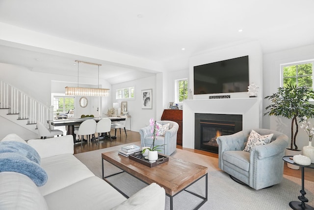 27 Lavender Ln, Rye Brook, NY 10573 - living area featuring wood finished floors, a glass covered fireplace, stairway, and recessed lighting
