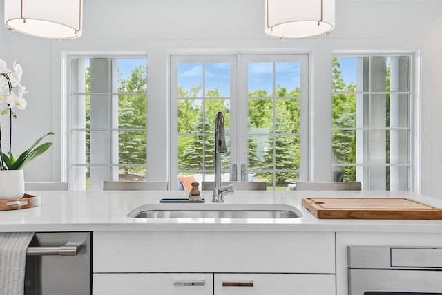27 Lavender Ln, Rye Brook, NY 10573 - kitchen featuring light countertops, plenty of natural light, and white cabinets
