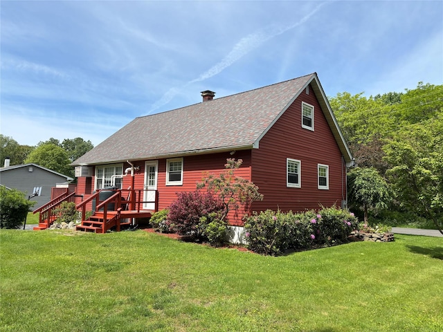 6 Windmill Rd, Poughkeepsie, NY 12601 - rear view of property featuring roof with shingles, a chimney, and a lawn