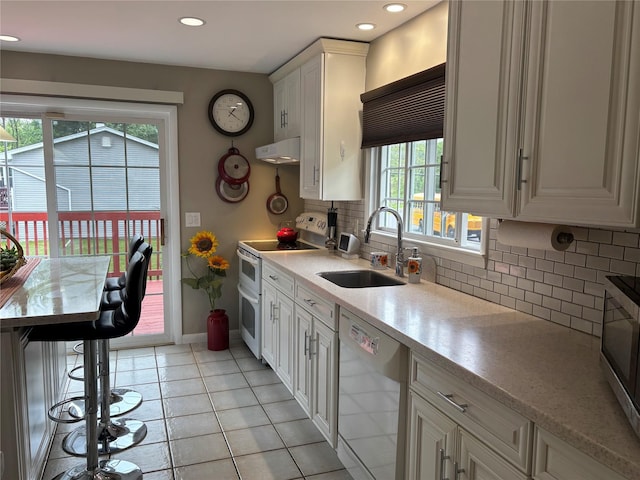 6 Windmill Rd, Poughkeepsie, NY 12601 - kitchen with appliances with stainless steel finishes, a sink, extractor fan, decorative backsplash, and recessed lighting