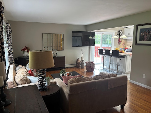 6 Windmill Rd, Poughkeepsie, NY 12601 - living area featuring wood finished floors, baseboards, and baseboard heating