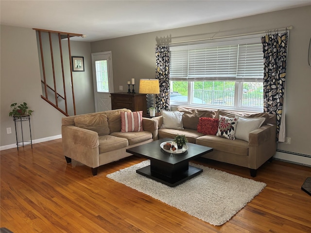 6 Windmill Rd, Poughkeepsie, NY 12601 - living area with wood finished floors, healthy amount of natural light, stairs, and baseboard heating