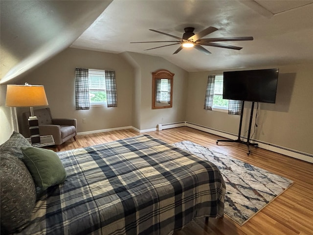 6 Windmill Rd, Poughkeepsie, NY 12601 - bedroom featuring multiple windows, wood finished floors, lofted ceiling, and a baseboard radiator