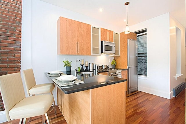 161 W 133rd St, New York Manhattan, NY 10030 - kitchen featuring white microwave, freestanding refrigerator, dark countertops, a sink, and dark wood-type flooring