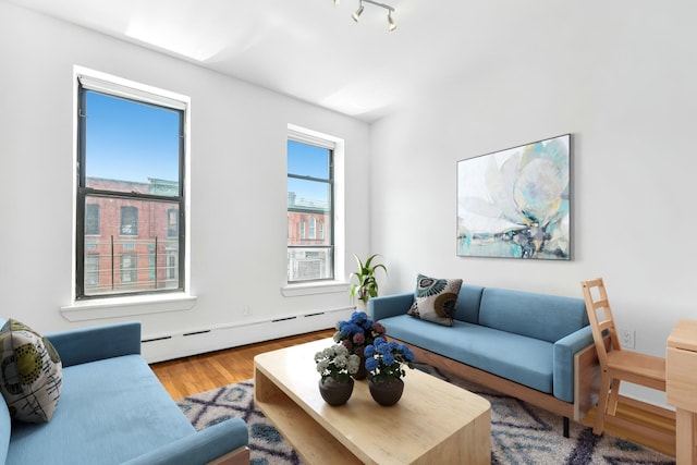 161 W 133rd St, New York Manhattan, NY 10030 - living room featuring a baseboard heating unit and wood finished floors