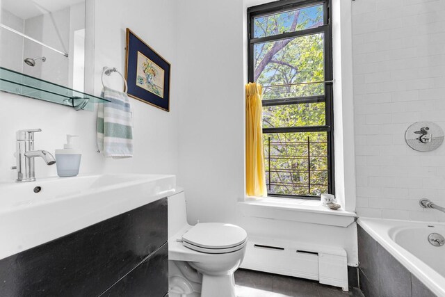 161 W 133rd St, New York Manhattan, NY 10030 - full bath with a baseboard heating unit, plenty of natural light, toilet, and tile patterned floors
