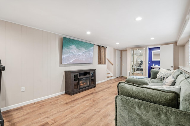 422 Old Bridge Rd, Northport, NY 11768 - living room with stairway, wood finished floors, baseboards, recessed lighting, and a glass covered fireplace