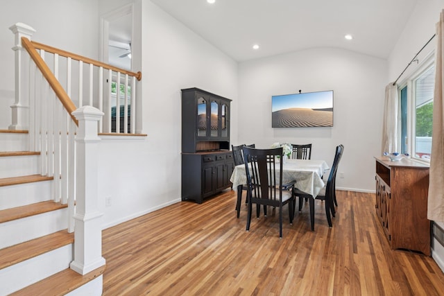 422 Old Bridge Rd, Northport, NY 11768 - dining room featuring light wood finished floors, lofted ceiling, recessed lighting, stairway, and baseboards