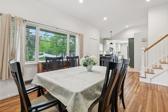 422 Old Bridge Rd, Northport, NY 11768 - dining area featuring recessed lighting, light wood-style floors, stairs, baseboards, and vaulted ceiling