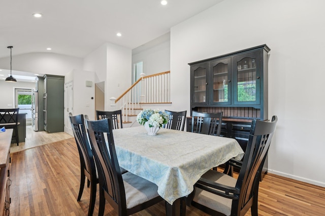 422 Old Bridge Rd, Northport, NY 11768 - dining area with light wood-type flooring, stairs, recessed lighting, vaulted ceiling, and baseboards