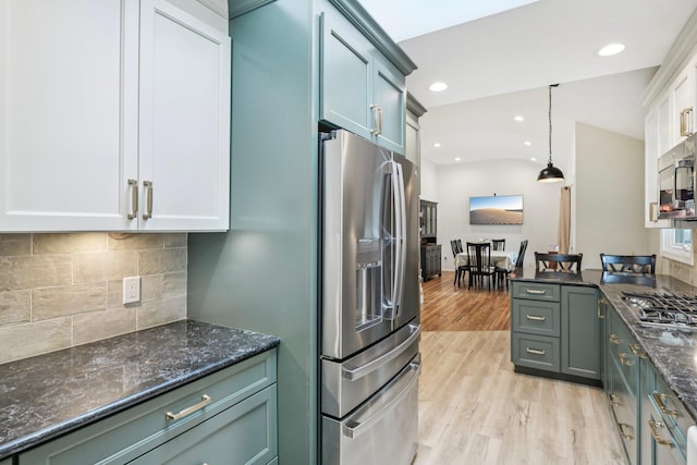422 Old Bridge Rd, Northport, NY 11768 - kitchen featuring appliances with stainless steel finishes, light wood-style floors, backsplash, dark stone counters, and recessed lighting