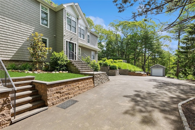 79 Oakside Rd, Smithtown, NY 11787 - view of patio / terrace featuring a detached garage, an outdoor structure, stairway, and driveway