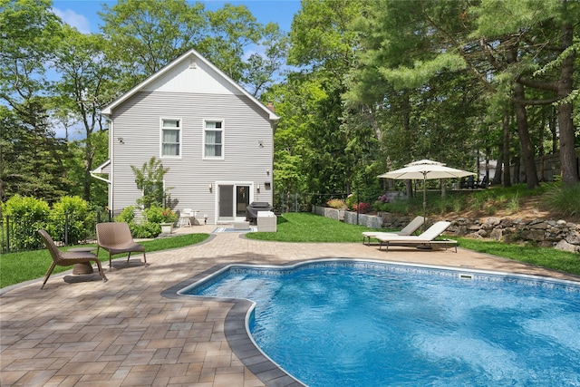 79 Oakside Rd, Smithtown, NY 11787 - rear view of property with a patio, an outdoor pool, and view of wooded area