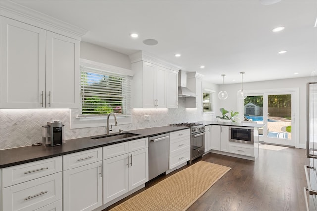 79 Oakside Rd, Smithtown, NY 11787 - kitchen with appliances with stainless steel finishes, a peninsula, white cabinetry, plenty of natural light, and recessed lighting