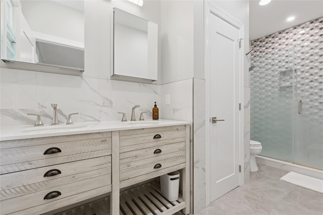 79 Oakside Rd, Smithtown, NY 11787 - bathroom with tile walls, double vanity, a shower stall, and recessed lighting