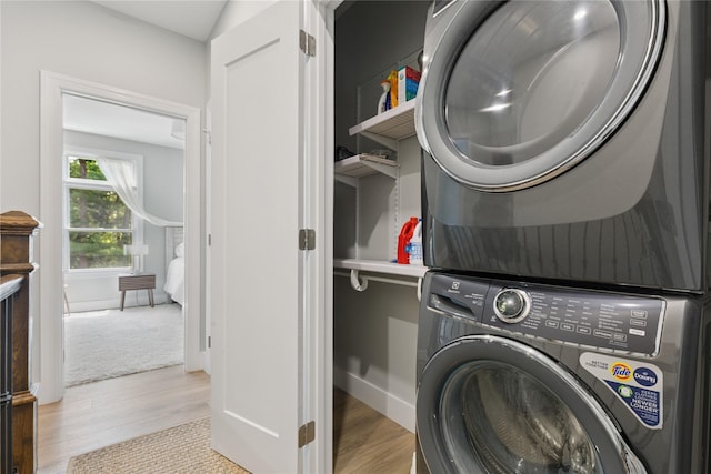79 Oakside Rd, Smithtown, NY 11787 - washroom with stacked washer and clothes dryer and light wood-type flooring