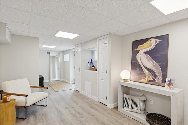 79 Oakside Rd, Smithtown, NY 11787 - living area featuring a drop ceiling and wood finished floors