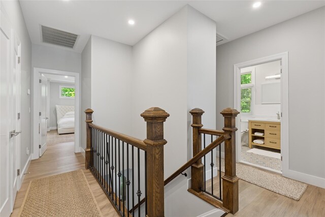 79 Oakside Rd, Smithtown, NY 11787 - hall with an upstairs landing, light wood-type flooring, healthy amount of natural light, and recessed lighting