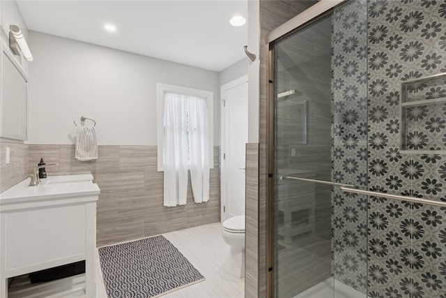79 Oakside Rd, Smithtown, NY 11787 - full bath featuring tile walls, vanity, wainscoting, tile patterned flooring, and a shower stall