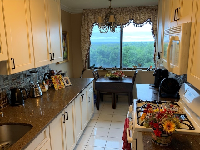 26910 Grand Central Pkwy Unit 8N, Floral Park, NY 11005 - kitchen with white appliances, a sink, light tile patterned floors, a chandelier, and dark stone countertops