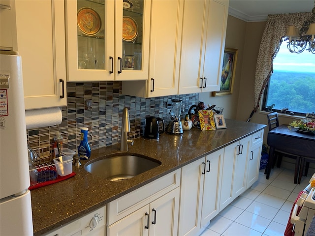26910 Grand Central Pkwy Unit 8N, Floral Park, NY 11005 - kitchen with a sink, freestanding refrigerator, white cabinetry, crown molding, and dark stone counters