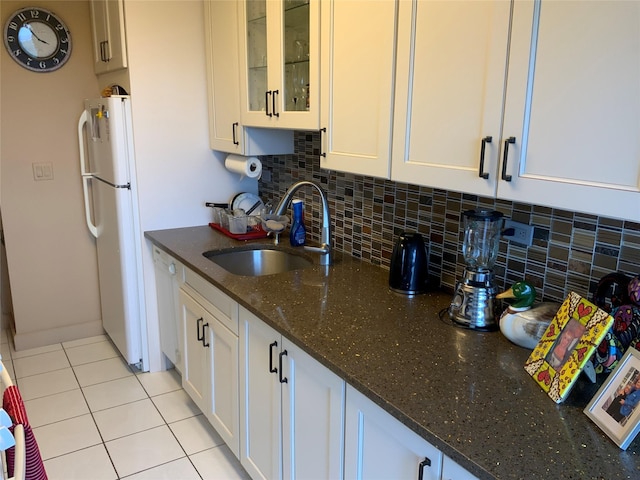 26910 Grand Central Pkwy Unit 8N, Floral Park, NY 11005 - kitchen featuring white appliances, a sink, white cabinets, decorative backsplash, and dark stone countertops
