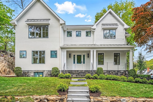 2 Lavender Ln, Rye, NY 10580 - modern inspired farmhouse with a standing seam roof, stone siding, covered porch, and a front lawn