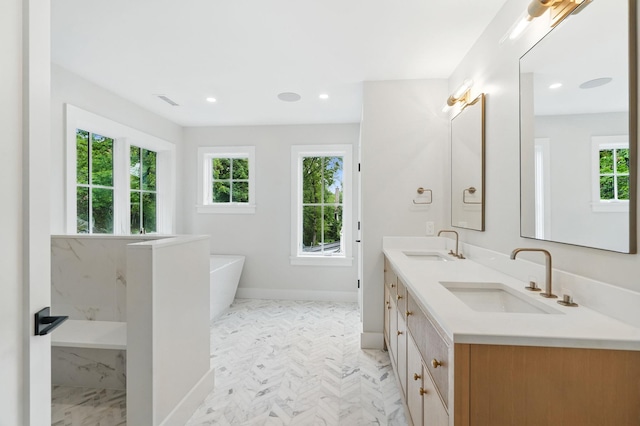 2 Lavender Ln, Rye, NY 10580 - full bath with marble look tile flooring, a freestanding tub, double vanity, baseboards, and recessed lighting