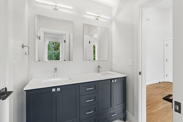 2 Lavender Ln, Rye, NY 10580 - bathroom featuring double vanity, wood finished floors, and baseboards