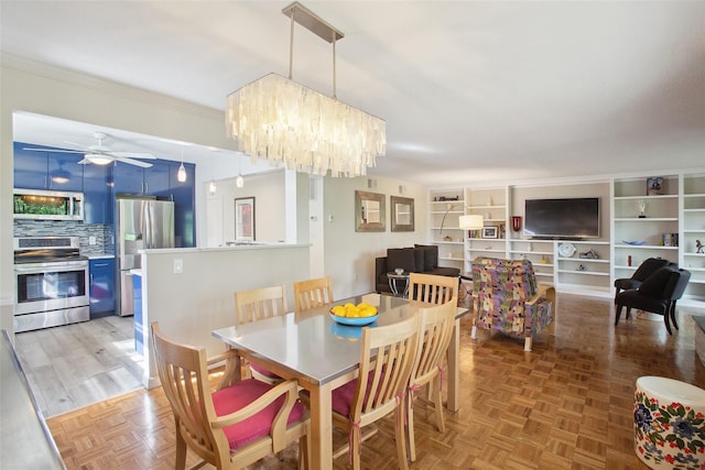 304 Heritage Hls Unit C, Somers, NY 10589 - dining area featuring a ceiling fan, ornamental molding, and a chandelier