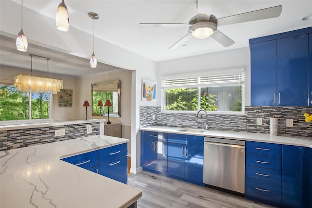 304 Heritage Hls Unit C, Somers, NY 10589 - kitchen featuring dishwasher, blue cabinets, decorative backsplash, and light stone countertops