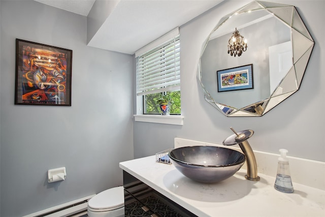 304 Heritage Hls Unit C, Somers, NY 10589 - bathroom with a baseboard heating unit, toilet, vanity, and a chandelier