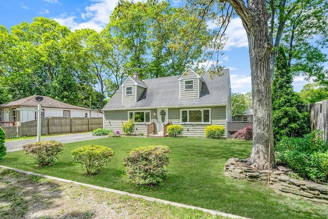 218 Beaver Dr, Mastic Beach, NY 11951 - new england style home with a chimney and a shingled roof