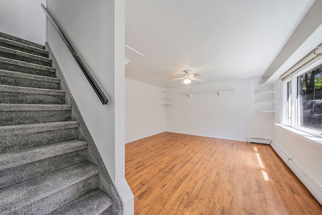 218 Beaver Dr, Mastic Beach, NY 11951 - staircase featuring wood finished floors, a ceiling fan, a baseboard heating unit, and baseboards