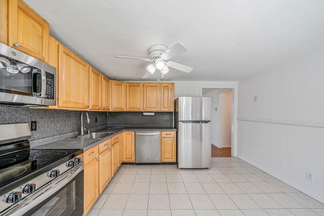 218 Beaver Dr, Mastic Beach, NY 11951 - kitchen with stainless steel appliances, a sink, a ceiling fan, dark countertops, and tasteful backsplash