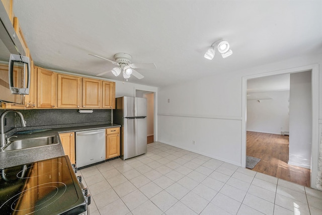 218 Beaver Dr, Mastic Beach, NY 11951 - kitchen featuring stainless steel appliances, a sink, a ceiling fan, light tile patterned flooring, and dark countertops