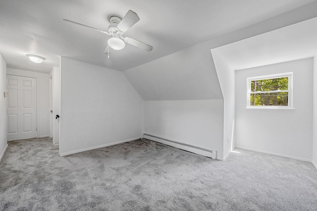 218 Beaver Dr, Mastic Beach, NY 11951 - additional living space with baseboard heating, carpet flooring, baseboards, a ceiling fan, and vaulted ceiling