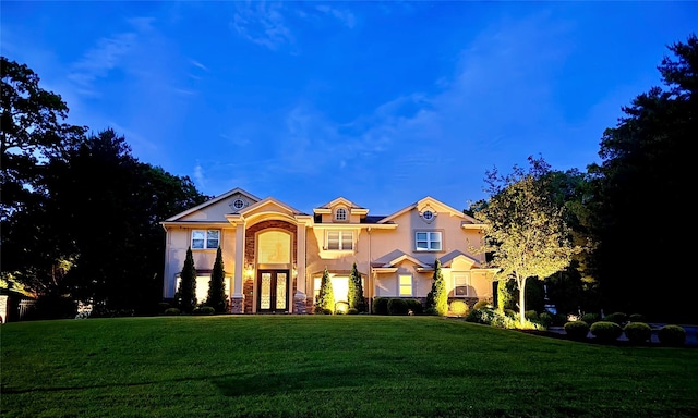 2 Maize Ct, Melville, NY 11747 - view of front facade with french doors, stucco siding, a front yard, and stone siding