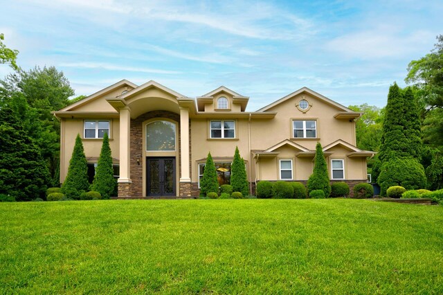 2 Maize Ct, Melville, NY 11747 - view of front facade with french doors, stucco siding, stone siding, and a front yard