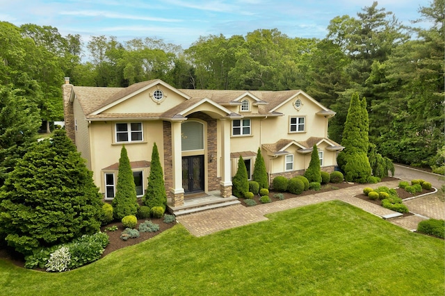 2 Maize Ct, Melville, NY 11747 - view of front of house featuring stucco siding, a chimney, stone siding, and a front lawn