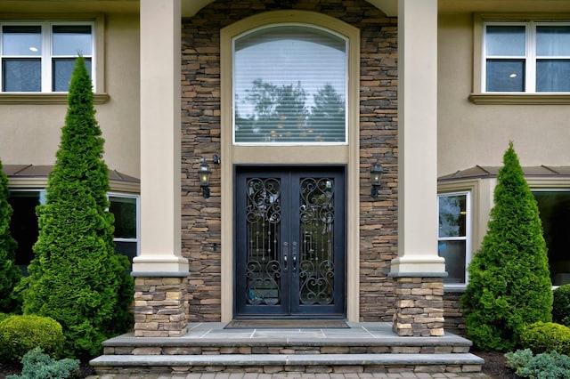 2 Maize Ct, Melville, NY 11747 - doorway to property with french doors, stucco siding, and stone siding
