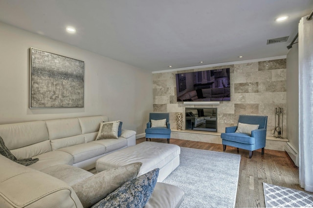 2 Maize Ct, Melville, NY 11747 - living room with wood finished floors, a baseboard heating unit, crown molding, and baseboards