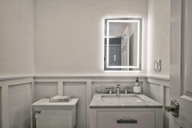 2 Maize Ct, Melville, NY 11747 - bathroom with a decorative wall, toilet, vanity, and wainscoting
