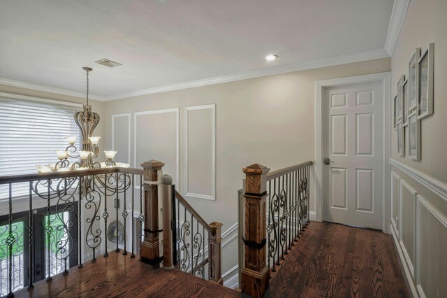 2 Maize Ct, Melville, NY 11747 - corridor featuring an upstairs landing, a chandelier, a decorative wall, wood finished floors, and ornamental molding