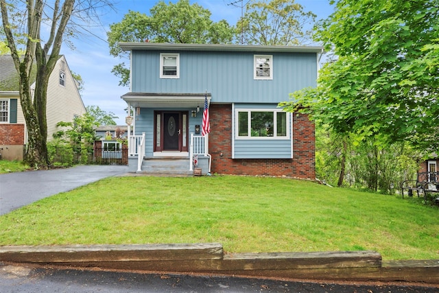 1A Ward St, Suffern, NY 10901 - view of front facade with a front yard, brick siding, and driveway