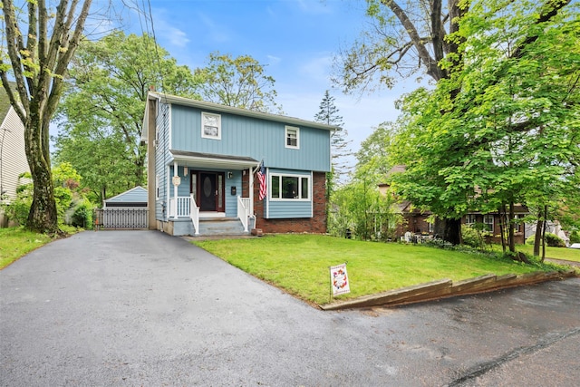 1A Ward St, Suffern, NY 10901 - view of front of house featuring a porch, brick siding, and a front lawn