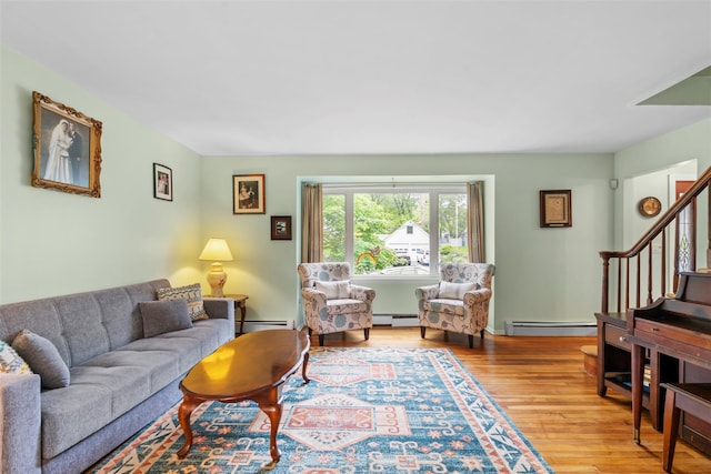 1A Ward St, Suffern, NY 10901 - living area with a baseboard heating unit, wood finished floors, baseboard heating, and stairway